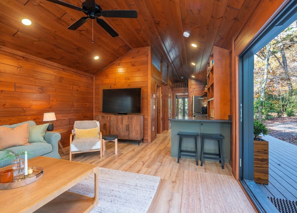 Living room with spacious sliding doors, wood-burning fireplace, and cozy seating