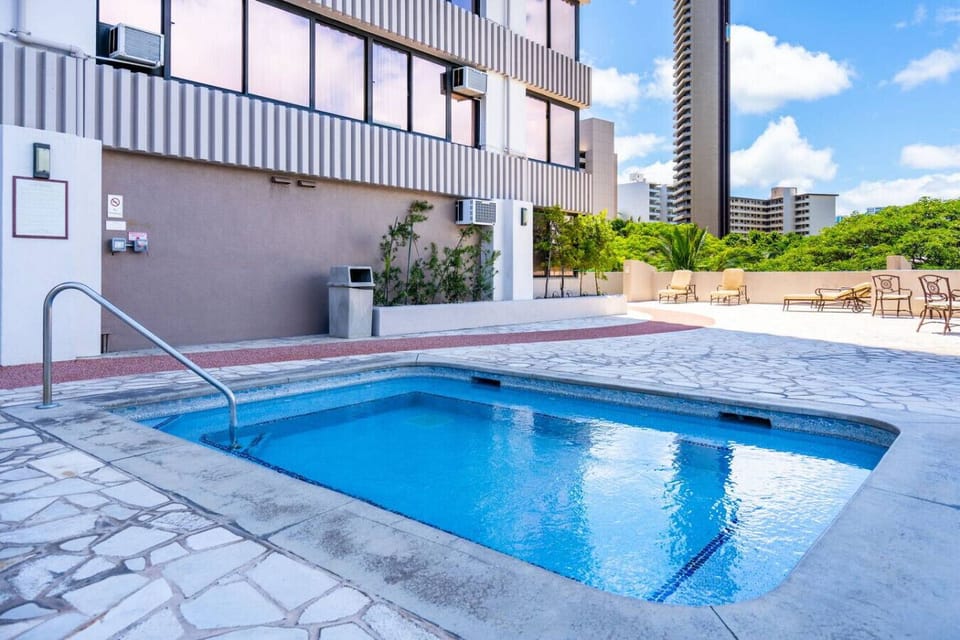 City views, blue skies, and poolside calm. This rooftop retreat is ready to refresh. Island living, elevated.