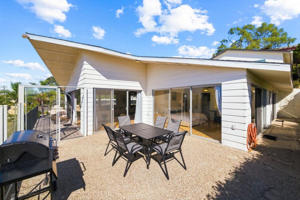 Step outside to a spacious patio with a BBQ grill and outdoor dining set. The perfect spot to relax and eat outside.