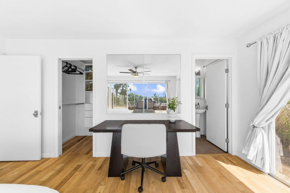 Bedroom 1: Includes a dedicated desk for remote work, a private ensuite bathroom, and a walk-in closet to keep you organized.
