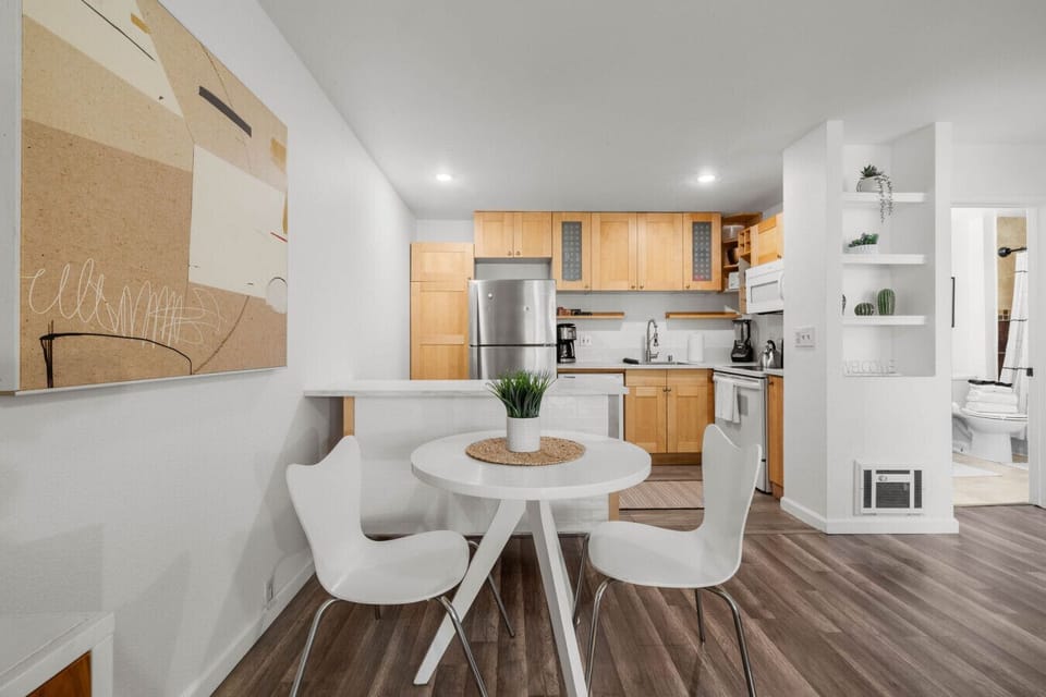Fully equipped kitchen with appliances and a dining nook perfect for meals at home.