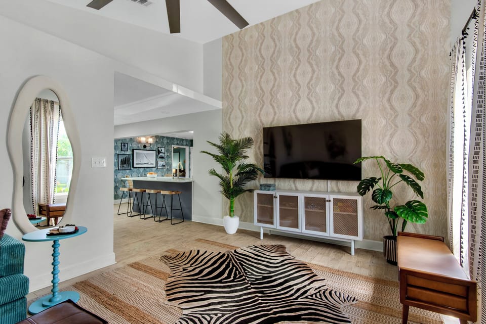 Living room with a large sectional sofa, tv, and modern decor.