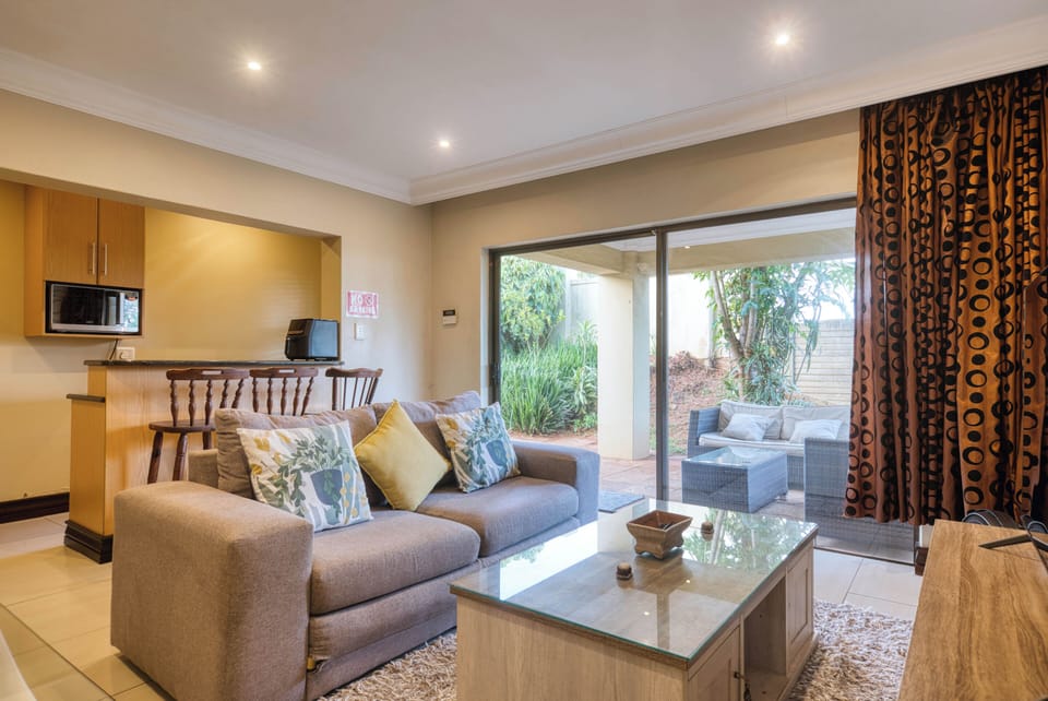 Spacious lounge with comfortable seating and TV