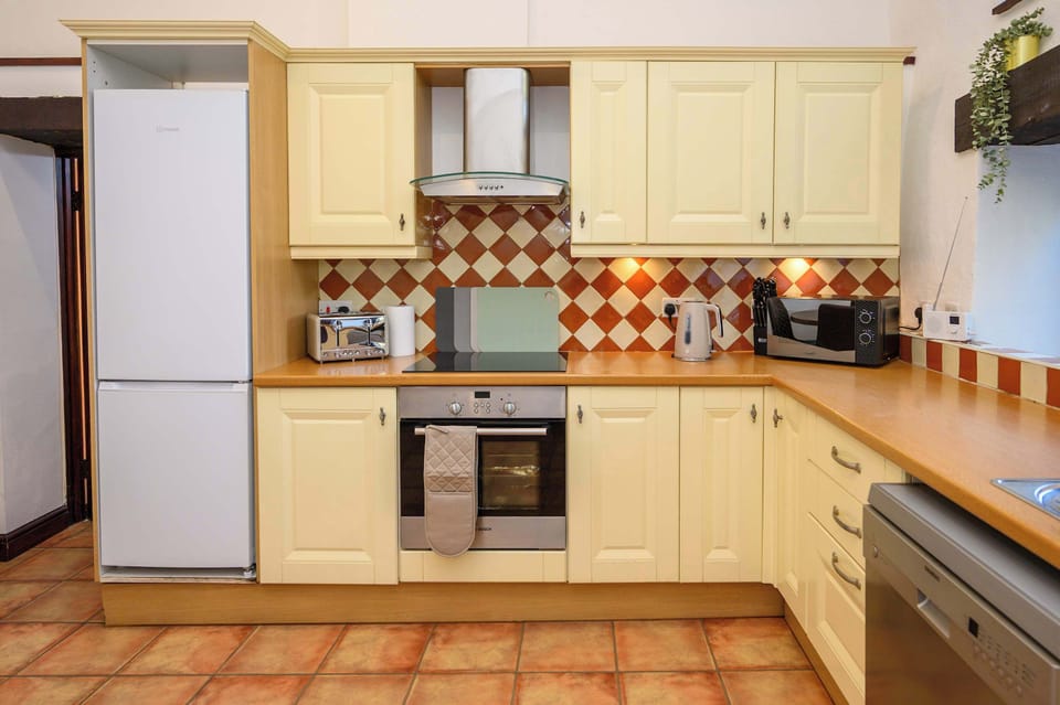 The spacious kitchen has everything you could need for this home from home, including cooker, microwave, oven, toaster, kettle and that all-important coffee machine.