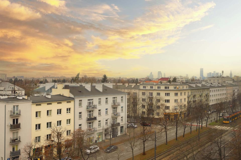 The sunset city view from the window lets guests soak in the local atmosphere, creating an inspiring backdrop for morning coffee or an unwinding evening moment.