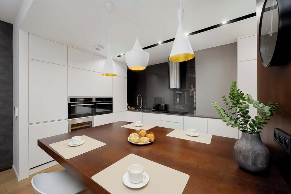 The thoughtfully designed kitchen with ambient lighting creates an elegant atmosphere where guests can cook freely or enjoy a peaceful morning ritual at the table.