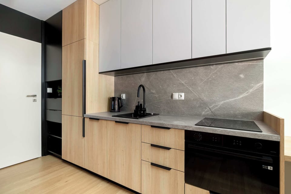 The sleek design of the kitchenette blending seamlessly with the living area.