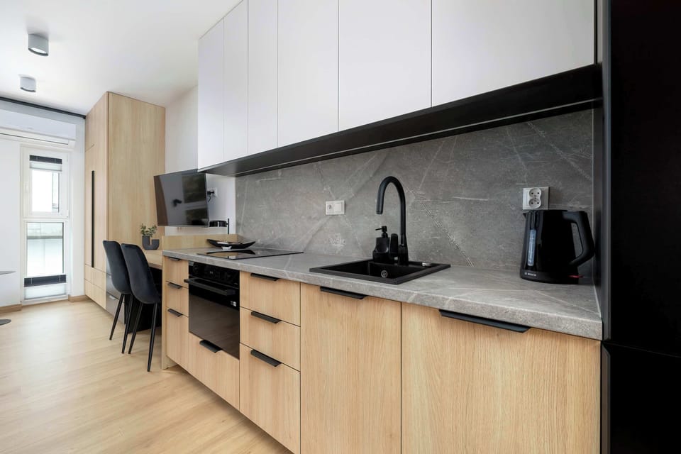 The sleek design of the kitchenette blending seamlessly with the living area.