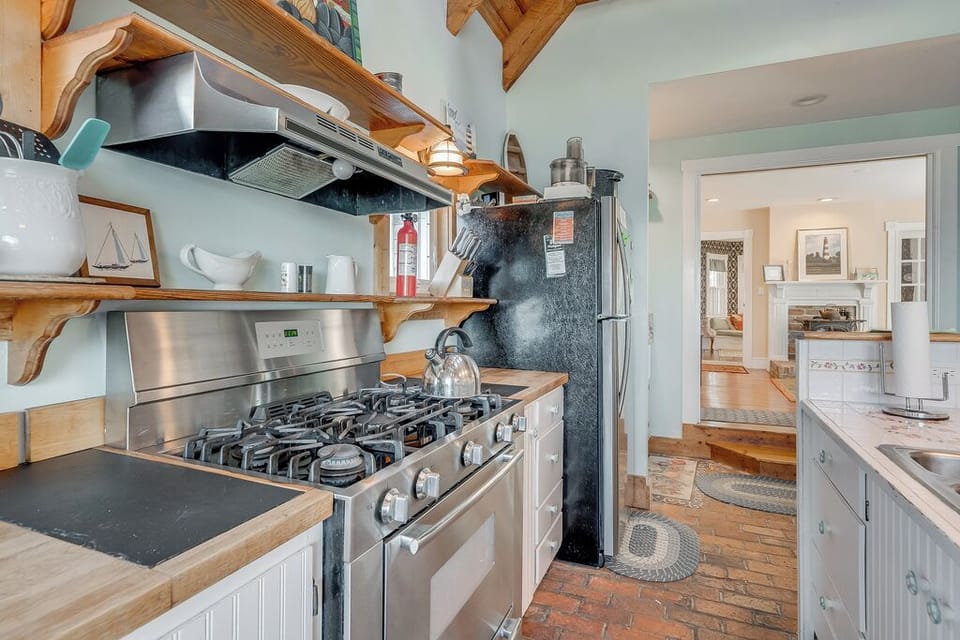 We adore the Kitchen with its Brick Flooring and Stainless Appliances.
