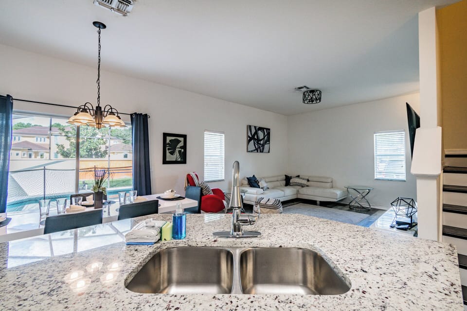 Enjoy a bright and airy open-concept space filled with natural light, featuring a beautiful granite countertop in the kitchen and stylish furnishings that create a warm, inviting atmosphere for your stay.