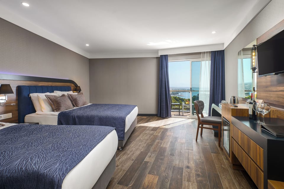 Standard Room, Partial Sea View | Free minibar, in-room safe, desk, laptop workspace