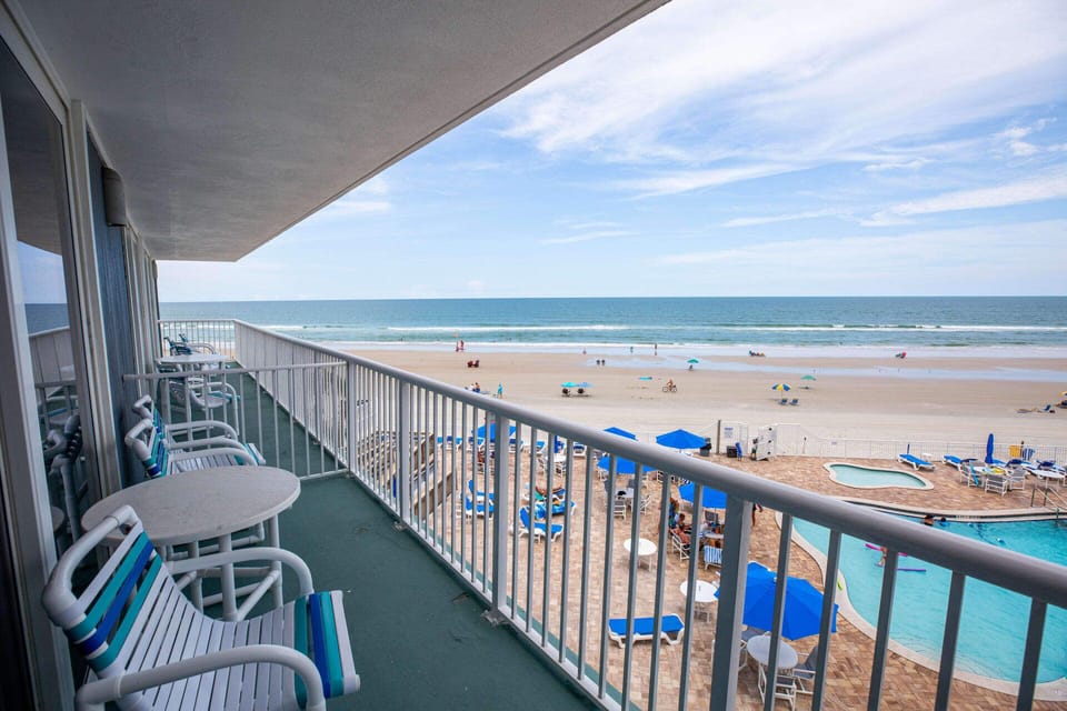 Enjoy breathtaking beach views from your private balcony, where you can relax and listen to the gentle waves while overlooking the vibrant beach scene below.