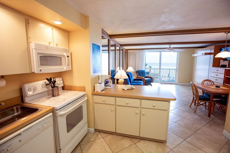 The fully equipped kitchen offers modern appliances and ample counter space, making it easy to prepare meals while enjoying ocean vistas.