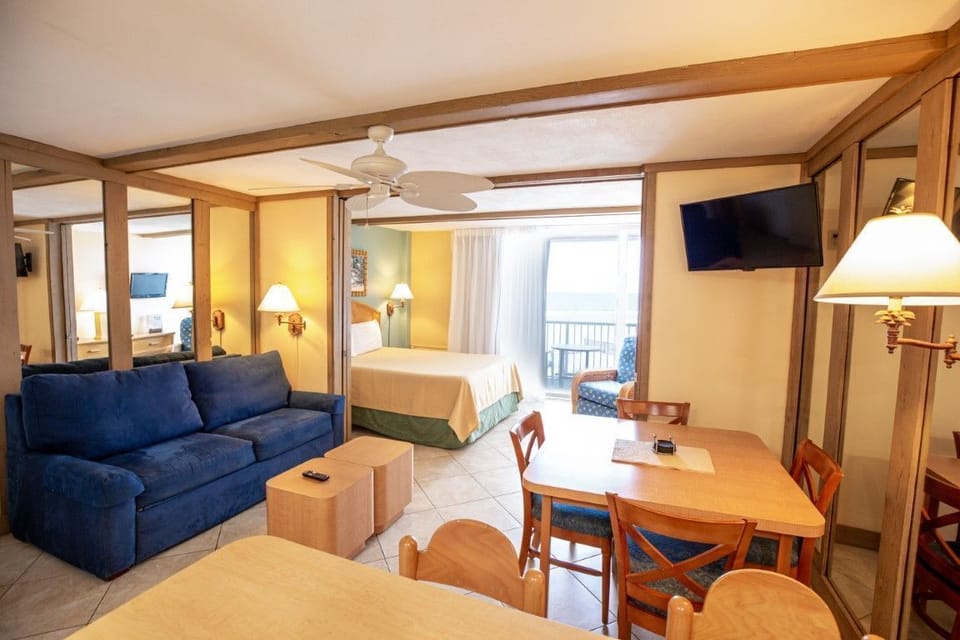 An inviting living space with a sofa bed and dining area, designed for comfort and convenience.