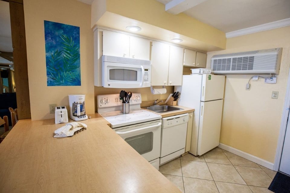 The kitchen showcases a stylish layout, with ample counter space and essential appliances, ideal for preparing delightful meals.