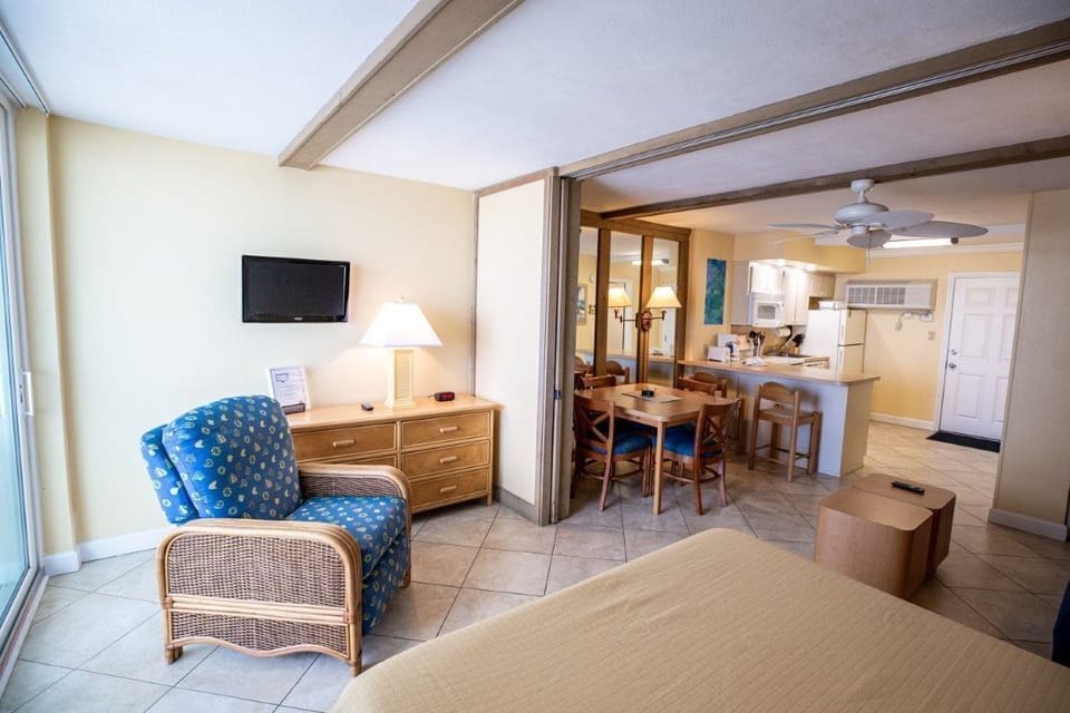 The inviting living area features a cozy blue chair and a functional dining space, perfect for enjoying meals together while taking in the serene ambiance.
