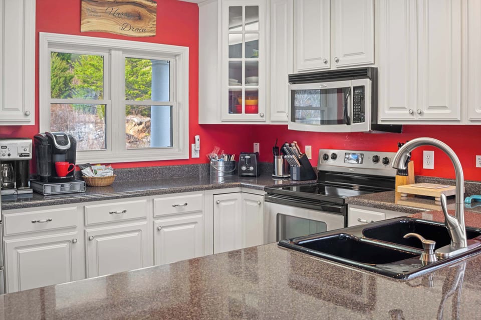 Whip up delicious meals in this vibrant space with sleek appliances and lovely views!