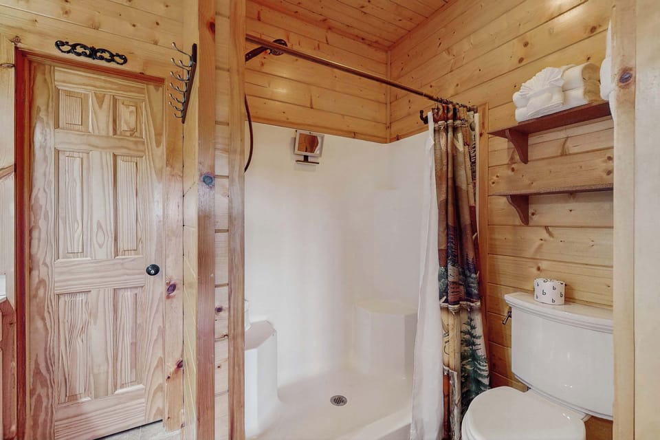 Enjoy a rustic vibe with wood accents and a spacious shower for refreshing moments!