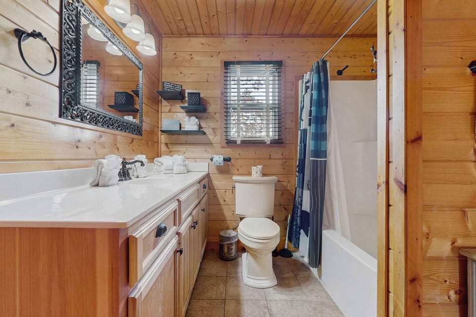 Discover rustic elegance with sleek fixtures, inviting light, and plush towels!