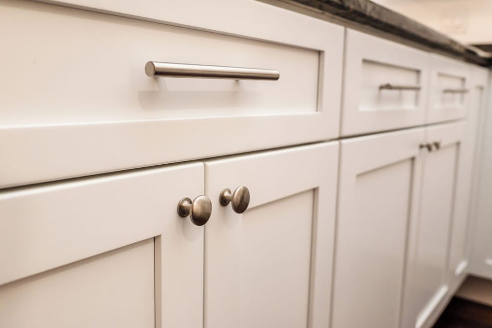 Brushed-nickel hardware on white shaker cabinets for a polished, cohesive look