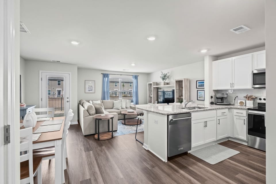 Open-concept floor plan seamlessly connecting the kitchen, dining, and living areas.