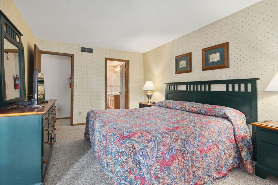 The tranquil bedroom invites restful sleep with its harmonious decor, offering a peaceful retreat with easy access to the bathroom.