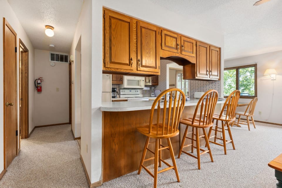 The well-equipped kitchen combines functionality with charm, complete with ample counter space and a breakfast bar.