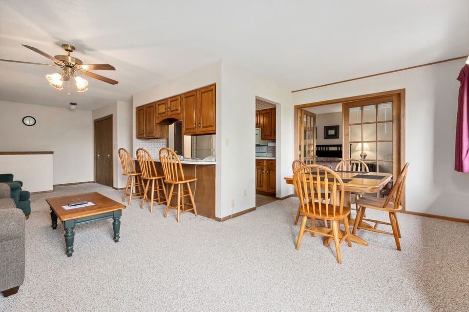 The spacious living area features cozy furnishings and a well-lit dining space, perfect for both relaxation and social gatherings.
