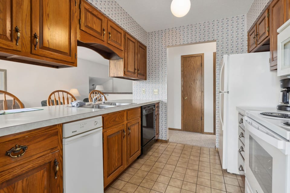 The fully-equipped kitchen features ample storage and modern appliances, ensuring both efficiency and comfort while preparing meals