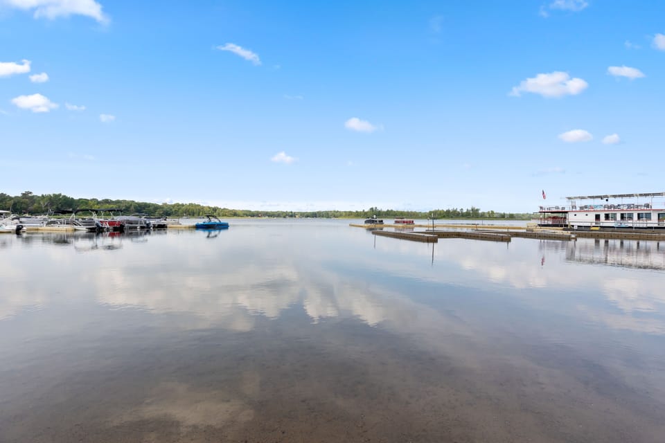 Open skies reflect on the peaceful lake.