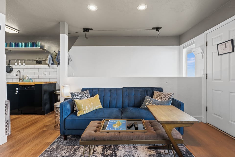 Our cozy living room features an electric fireplace, comfortable sofa that pulls out into a bed and a smart TV with cable. 
