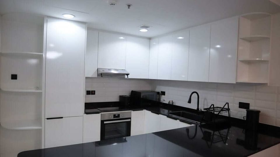 Fully equipped kitchen, with electric stove, built-in oven, dishwash tray, water kettle electric, toast maker and microwave oven. The refrigerator is also built-in. Chimney is fit. All cutleries are provided. Coffee mugs are placed in the drwaers.