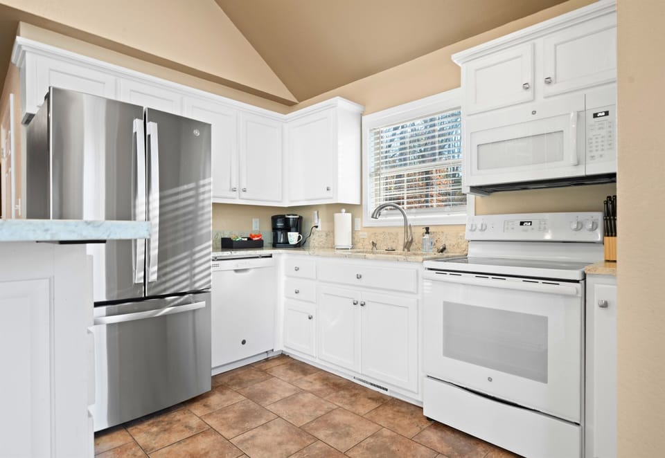 Bright cabinetry and updated appliances make it easy to prepare meals or snacks whenever hunger strikes.
