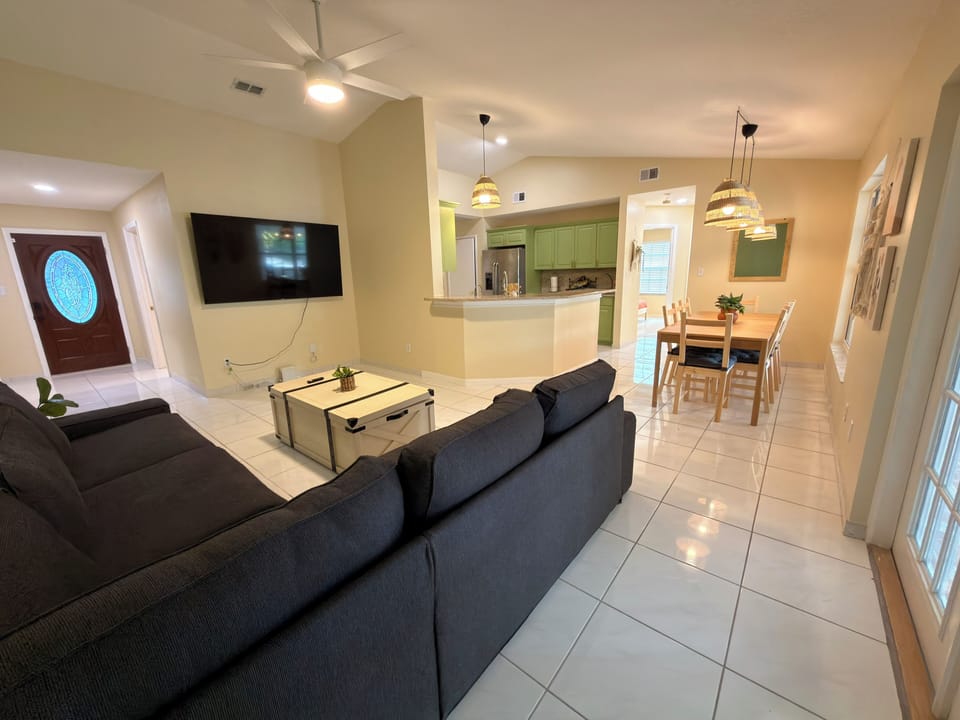 Open concept living room, 75" TV, Sectional, Ceiling fan