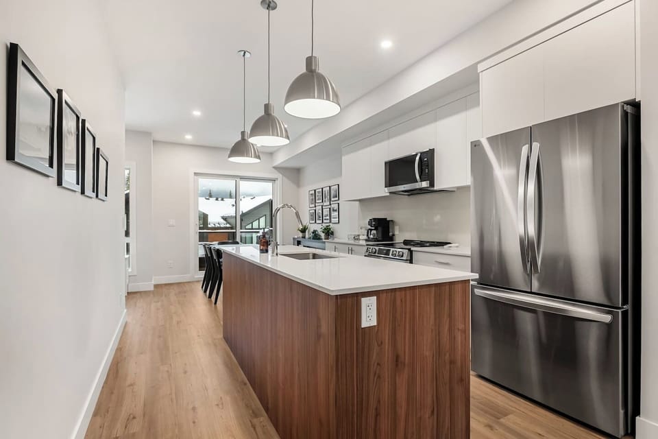 Full kitchen with a drip coffee machine, blender, ground coffee, tea, and sugar.