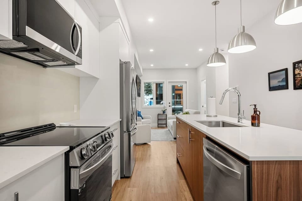 Full kitchen with a drip coffee machine, blender, ground coffee, tea, and sugar.