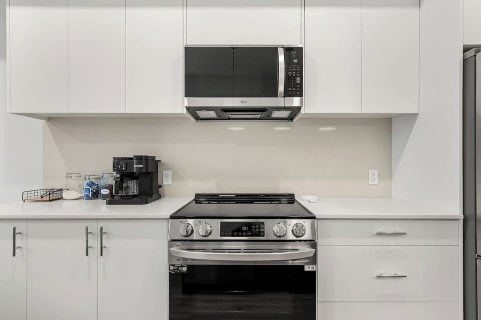 Full kitchen with a drip coffee machine, blender, ground coffee, tea, and sugar.