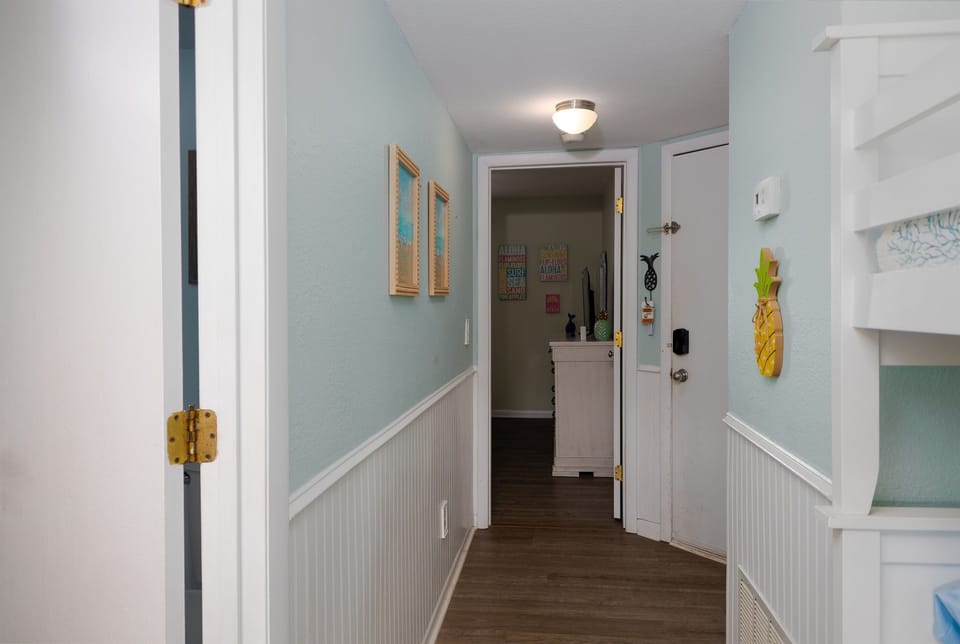 Hallway connecting the bunk area, bedroom, and main living space