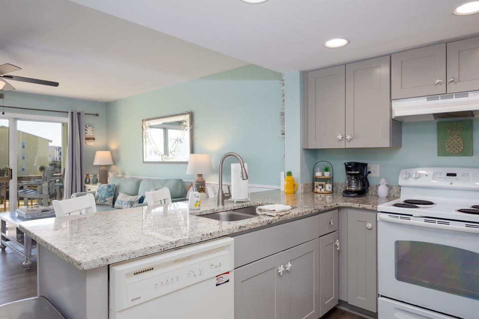 Beach-inspired kitchen overlooking the cozy living area