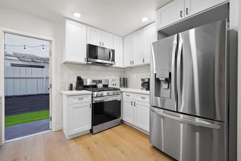 Sleek kitchen with stainless steel appliances and clean contemporary design.