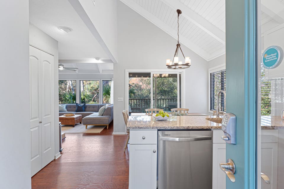 Step inside to a bright, open layout where vaulted ceilings and warm wood floors create an inviting first impression.