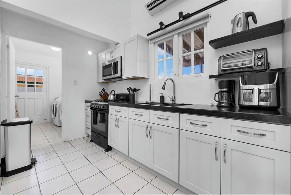 Our bright, fully equipped kitchen is ready for your morning coffee and home-cooked meals. Featuring a full stove, microwave, coffee maker, and toaster oven—you have everything you need to save money and dine in comfort.