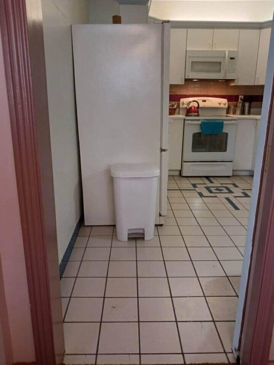 Entrance to the kitchen.  Refigerator to the right, stove in the middle.  Lot's of cabinet space.