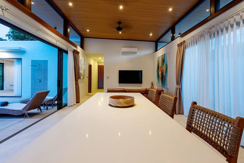 Grand open-plan living space - Full villa interior showcasing modern design and pool access