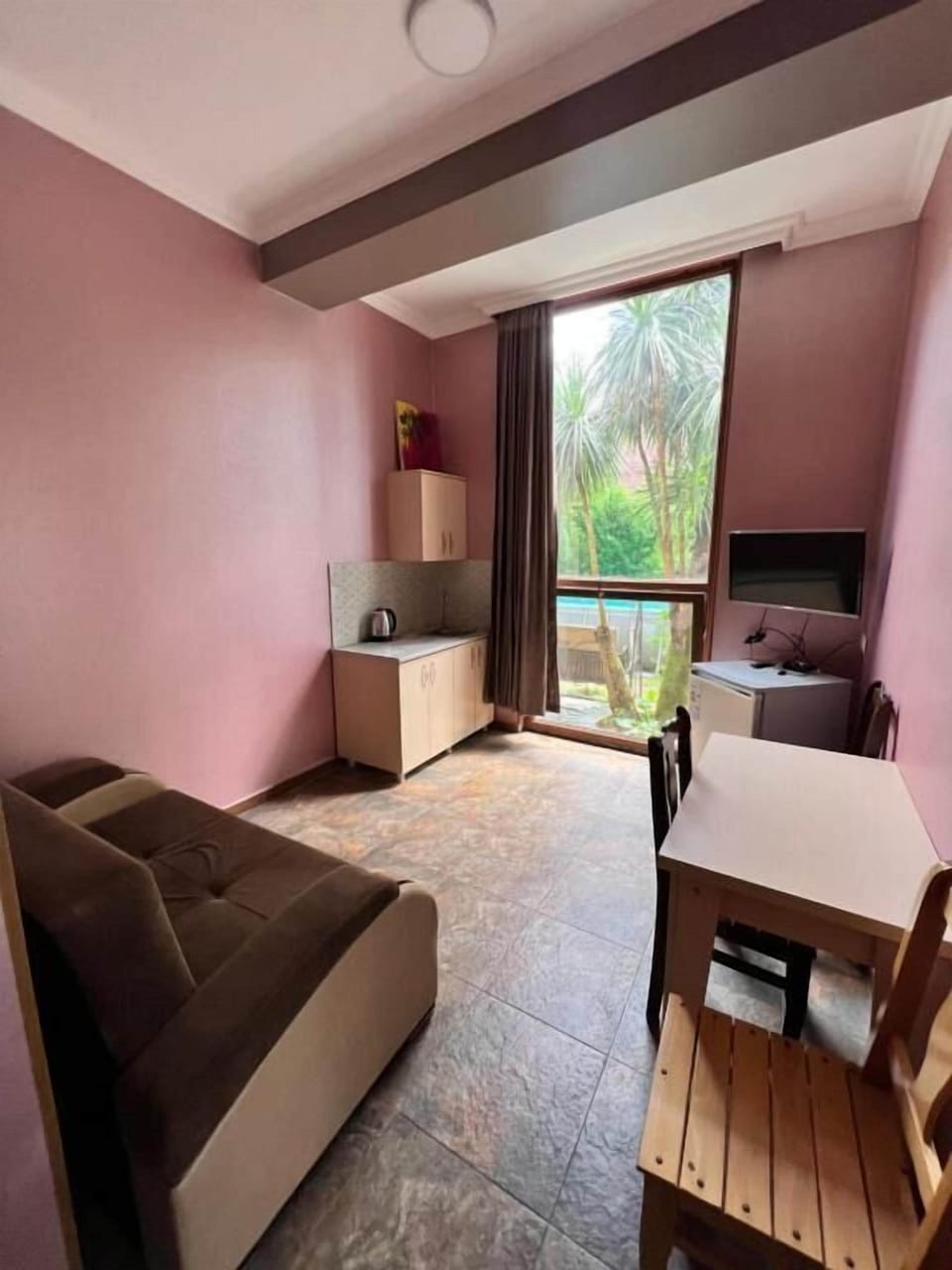Deluxe Quadruple Room | Living area | TV
