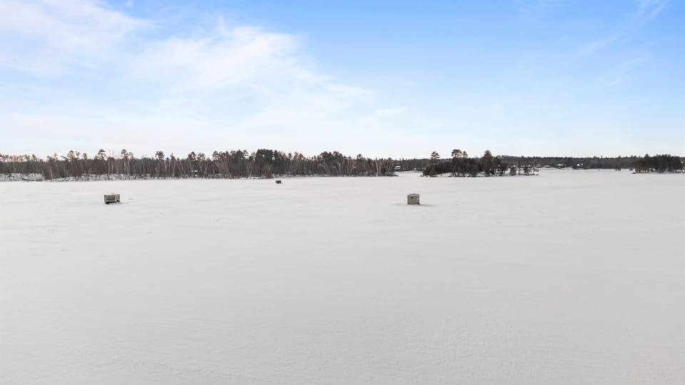 Winter on Clamshell Lake, part of the Whitefish Chain of Lakes, is quiet and wide open—snow-covered shoreline, frozen water, and crisp air that makes every walk, ride, or sunset feel unforgettable.