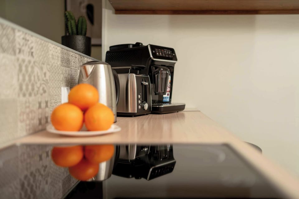 Close-up of the electric kettle and stovetop, toaster, and coffee maker.
