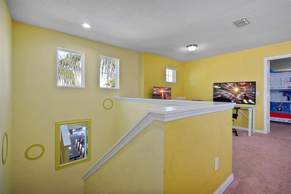A bright and functional upstairs loft that connects the bedrooms, providing a seamless transition between rest and work areas.