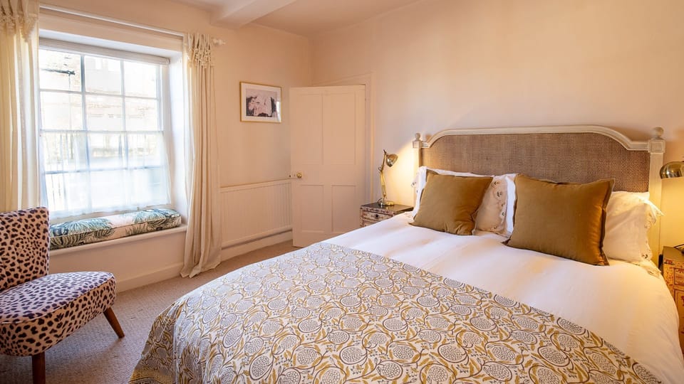 Unwind in the elegant master bedroom, Bell Cottage.