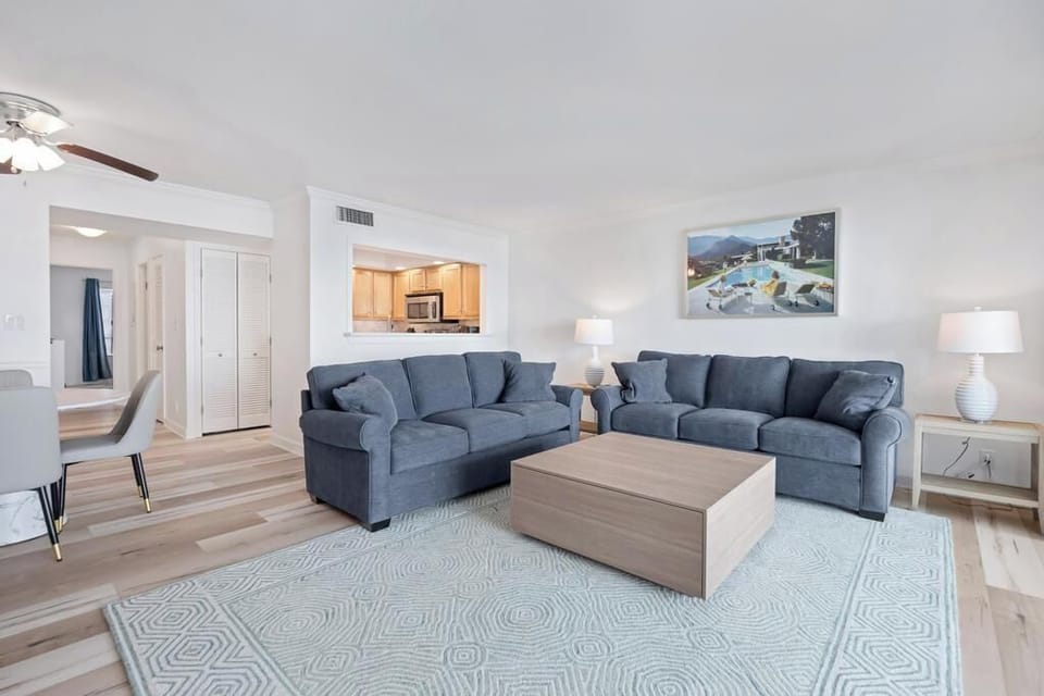 Relaxed living room setup w/ soft tones, comfy sofa & space to unwind.